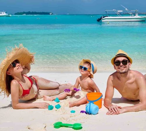 Family with three year old boy on beach