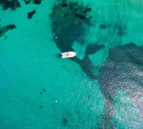 Aerial  view of a leisure boat mooring in translucent turquoise